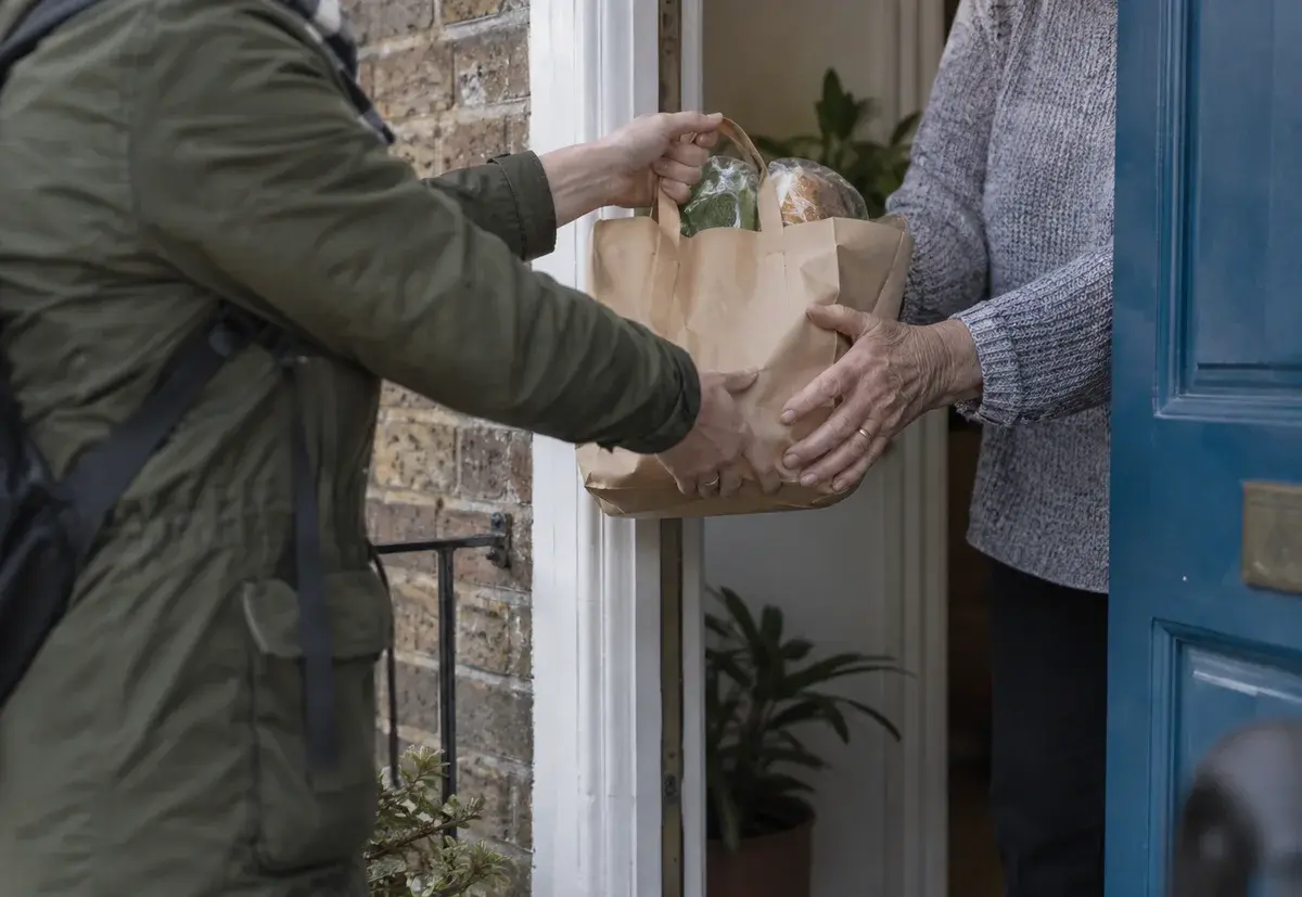 A care parcel being handed over at a neighbour’s door.